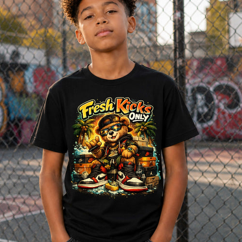 Child wearing a black t-shirt with 'Fresh Kicks Only' graphic design in an urban setting.