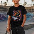 Person wearing a black t-shirt with a colorful graphic and text, holding a skateboard in a skate park.