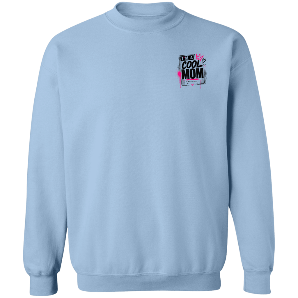 Person wearing a Light Blue sweatshirt with a graphic design Say's I'm A  Cool Mom on a city street.