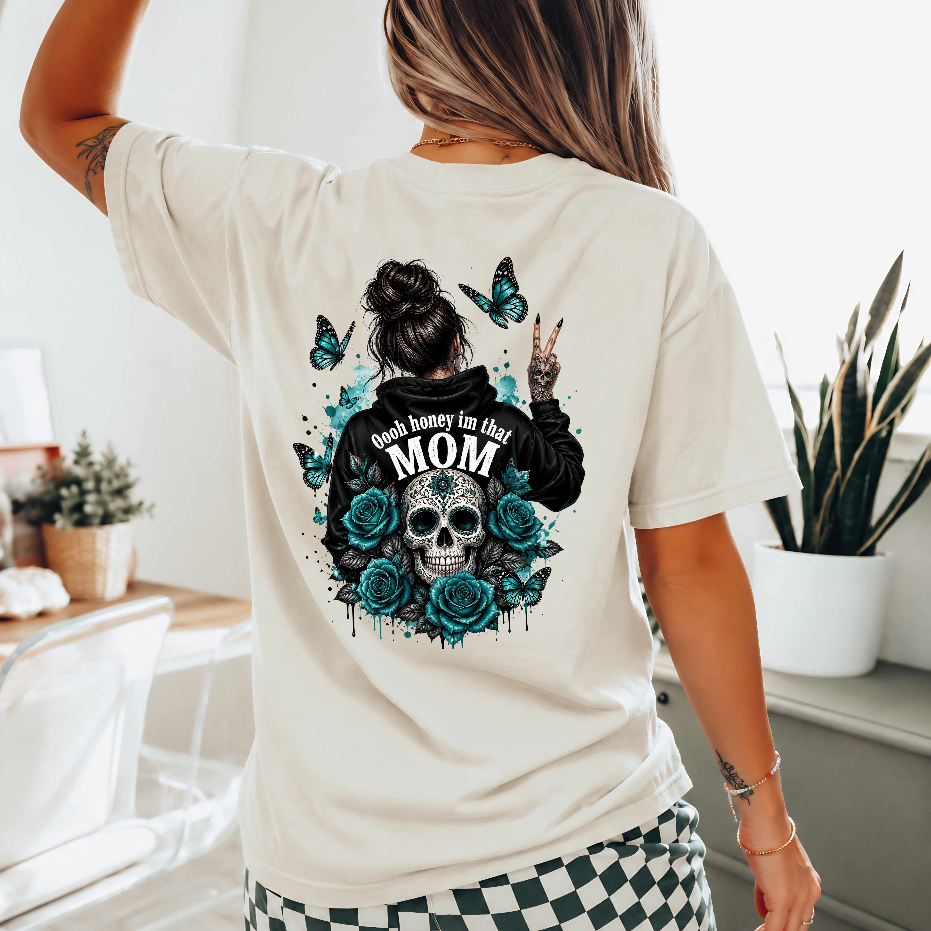 Person wearing a Natural t-shirt with a graphic design on the back, featuring a skull and roses, in a home setting.