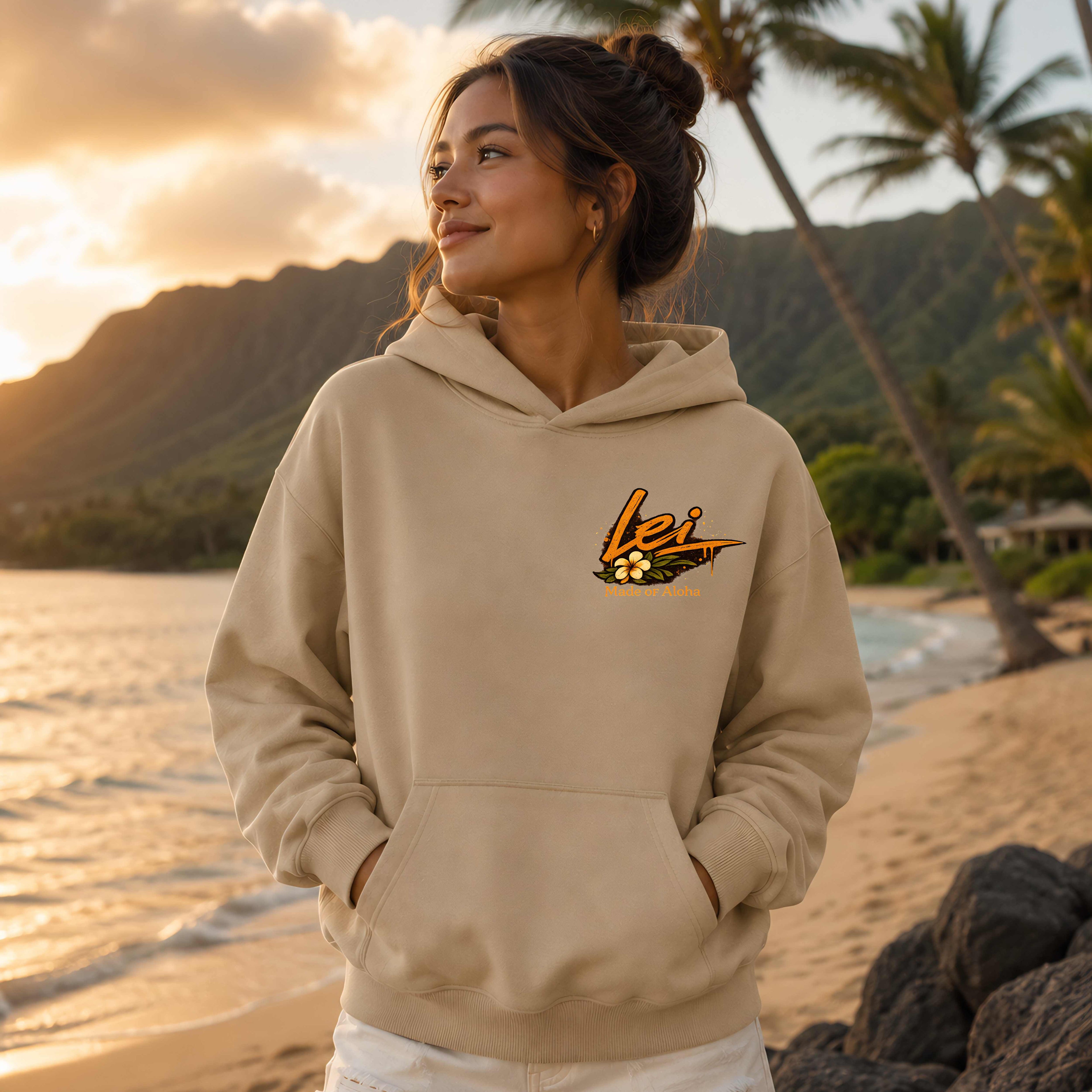 Woman wearing a Sand hoodie with 'Lei' logo on a beach at sunset