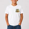 Person wearing a white t-shirt with a colorful graphic design on a plain background