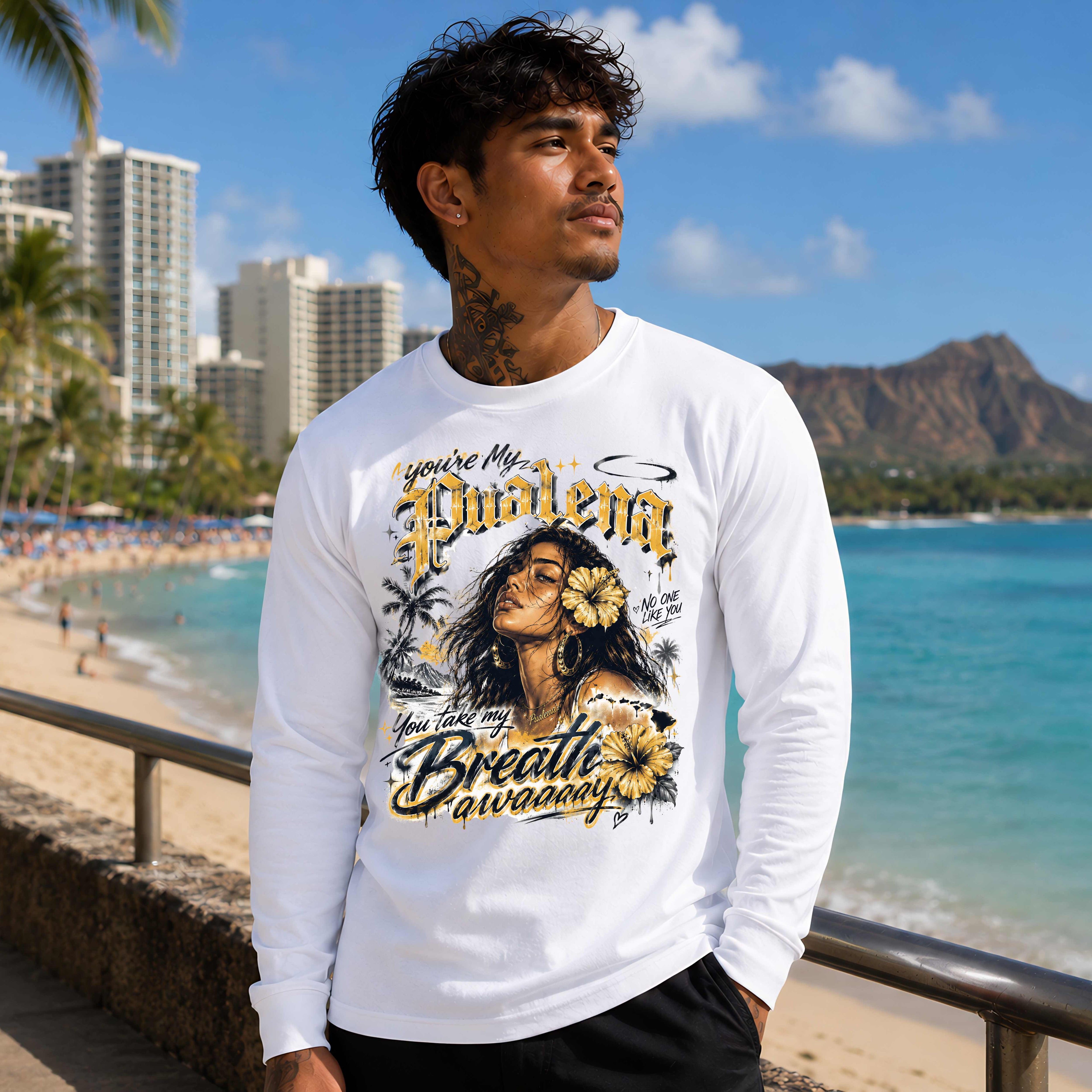 Man wearing a white long-sleeve shirt with a graphic design of a woman and text, standing on a beach with palm trees and buildings in the background.