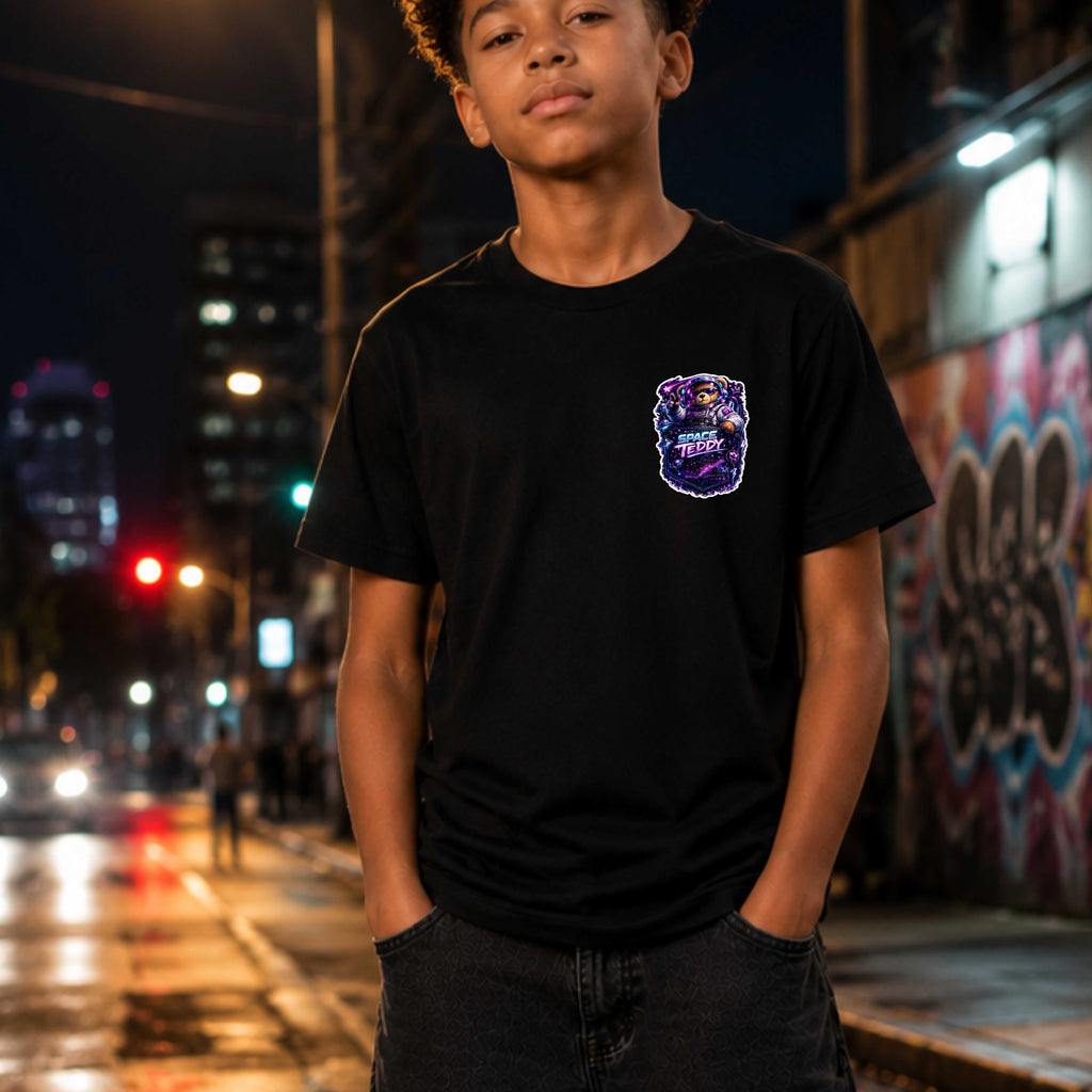 Young person wearing a black t-shirt with a purple logo on a city street at night.